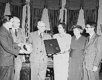 President Truman in the Oval Office with Katharine Lenroot in attendance (second from right), 1949. Truman was receiving a report on the work of UNICEF. (National Archives)